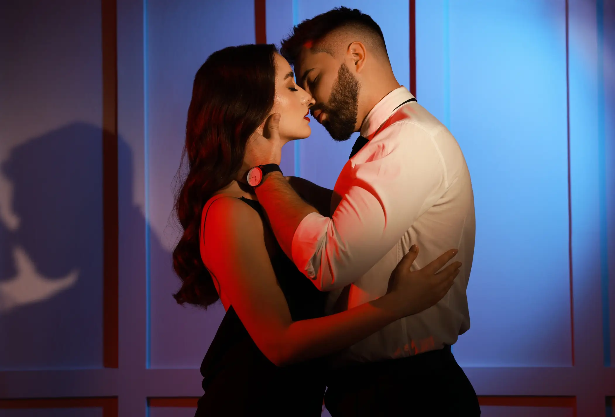 Handsome bearded man with sexy lady indoors